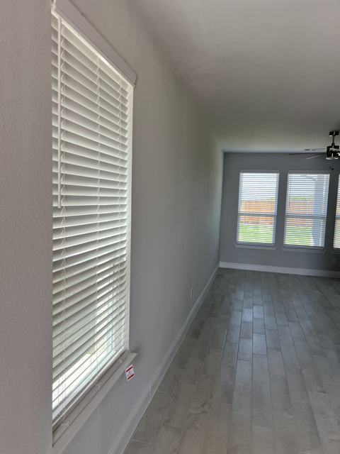 Long wood blind on a hallway window